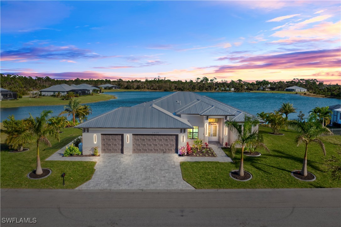 a aerial view of a house with a garden and lake view