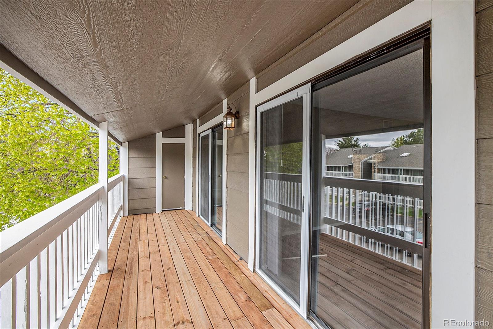 a view of balcony with wooden floor