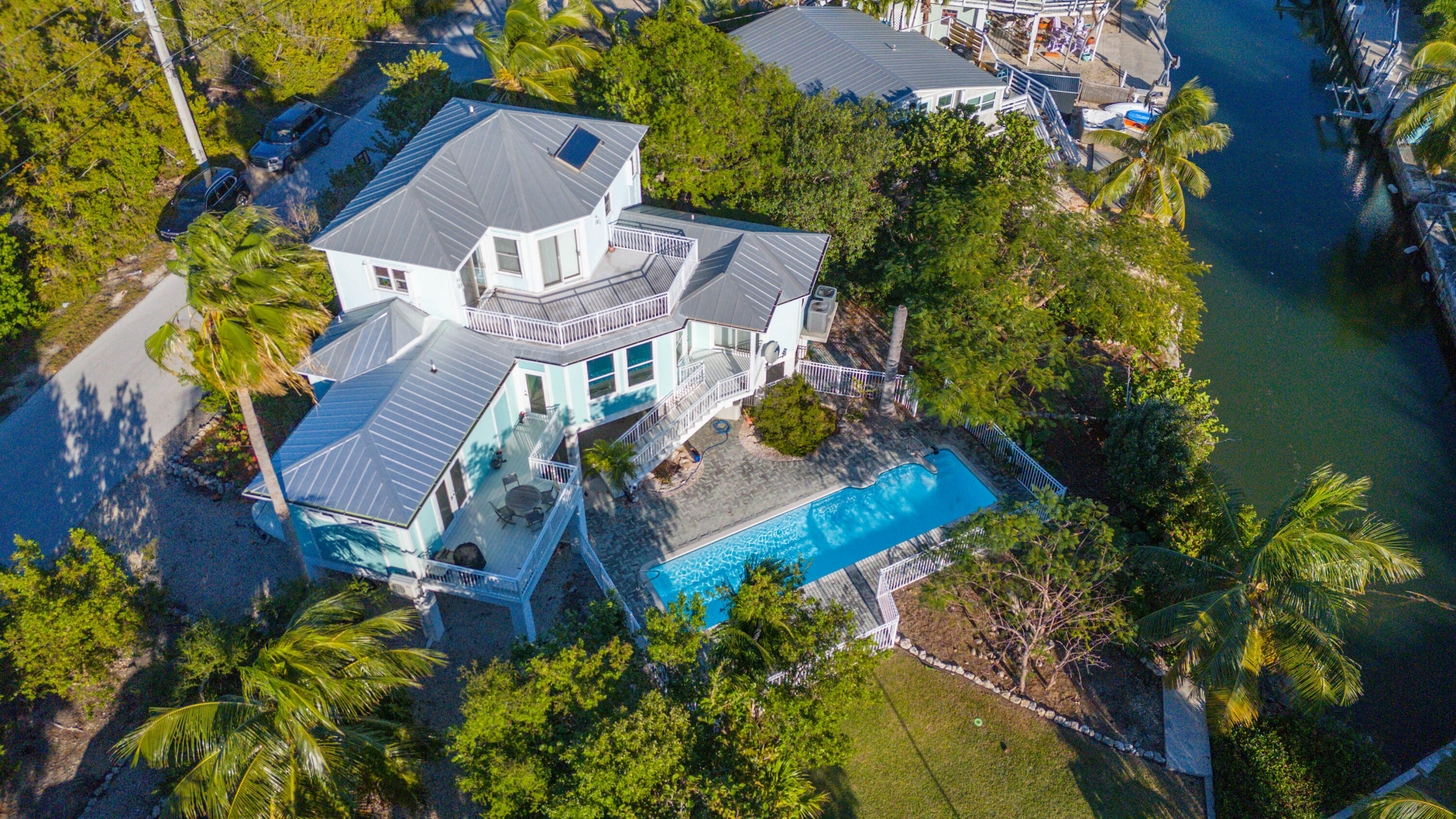 an aerial view of a house with a garden and lake view