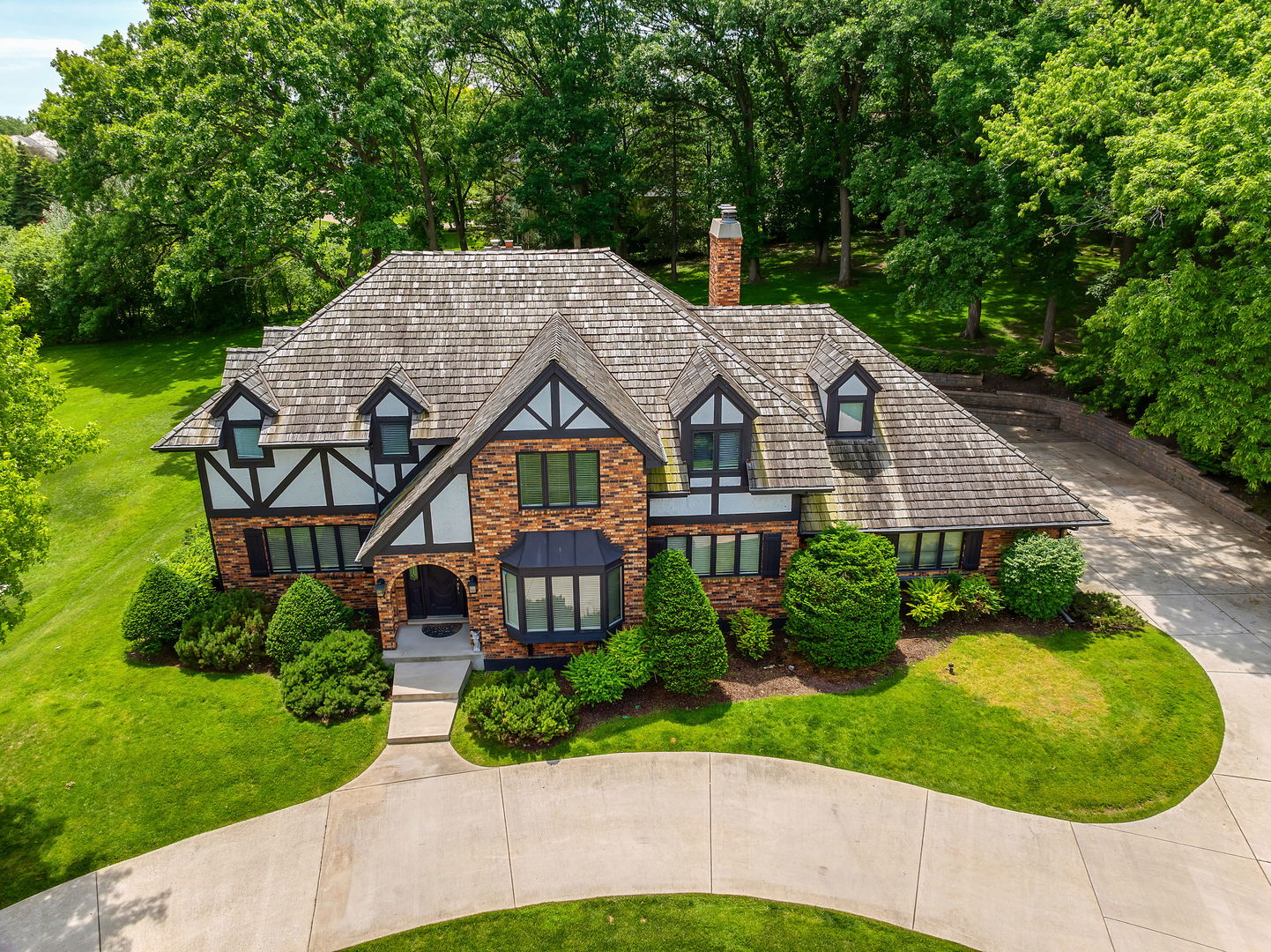 a aerial view of a house with a yard and potted plants