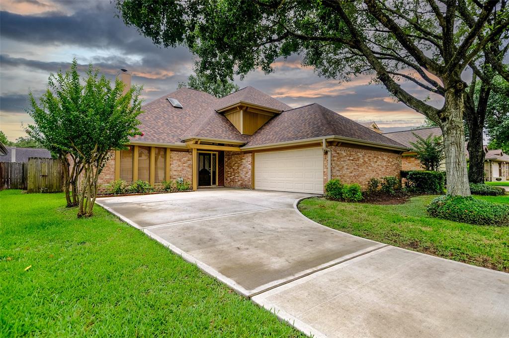 a front view of a house with a yard and a garage