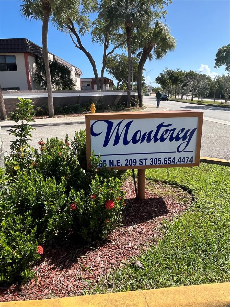 a sign that is sitting in front of flowers