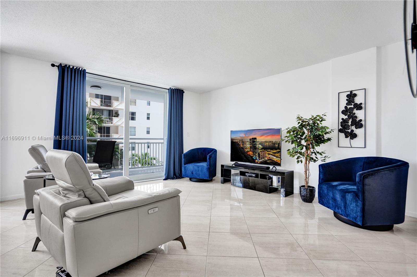 a living room with furniture large window and a fireplace