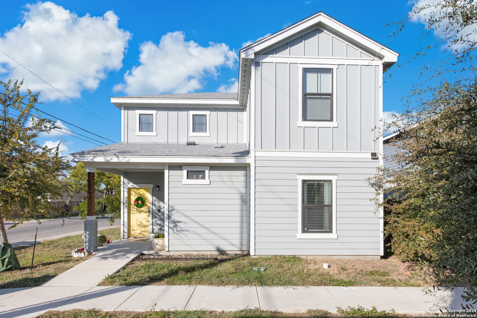 a front view of a house with a yard