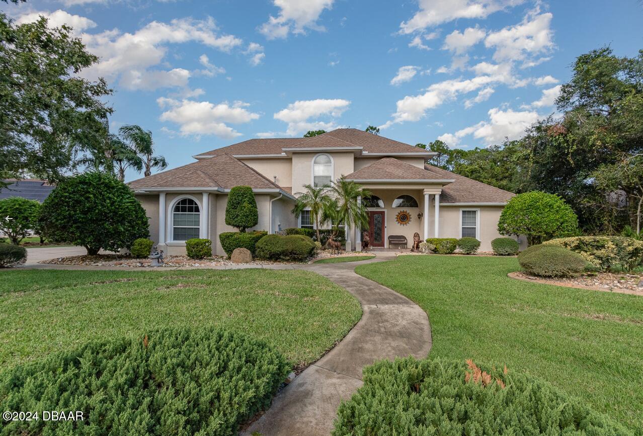 a front view of a house with garden