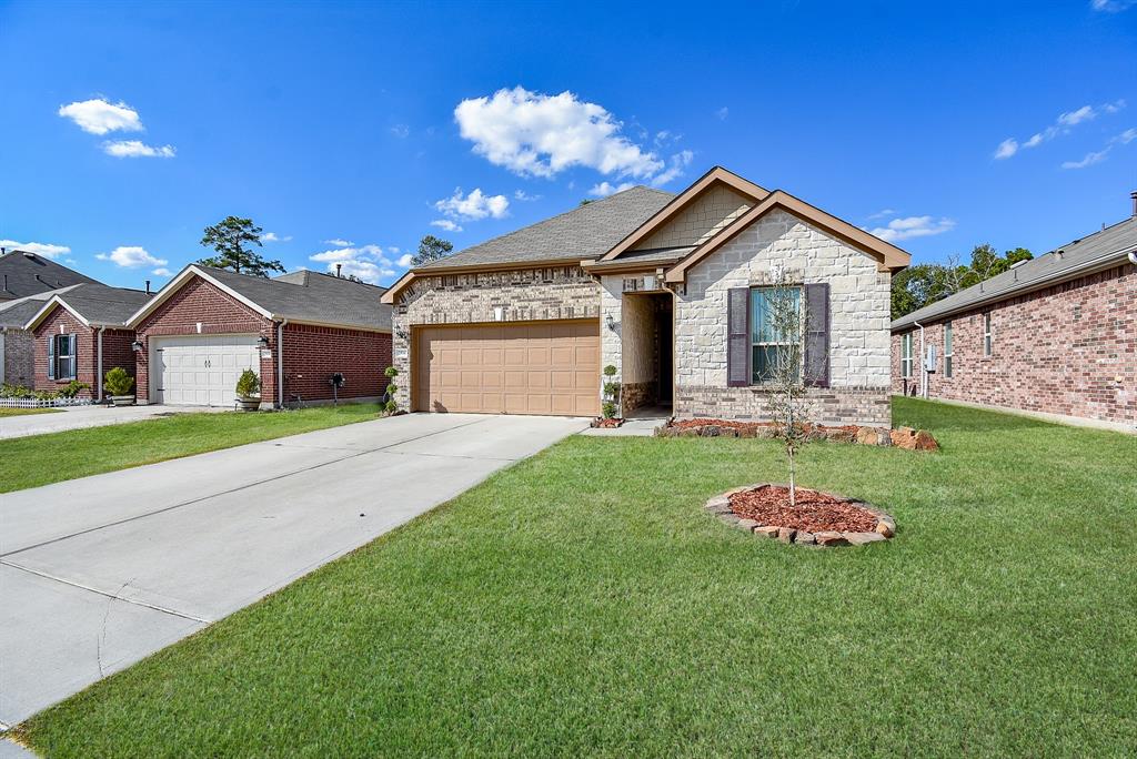 a front view of a house with a yard and garage