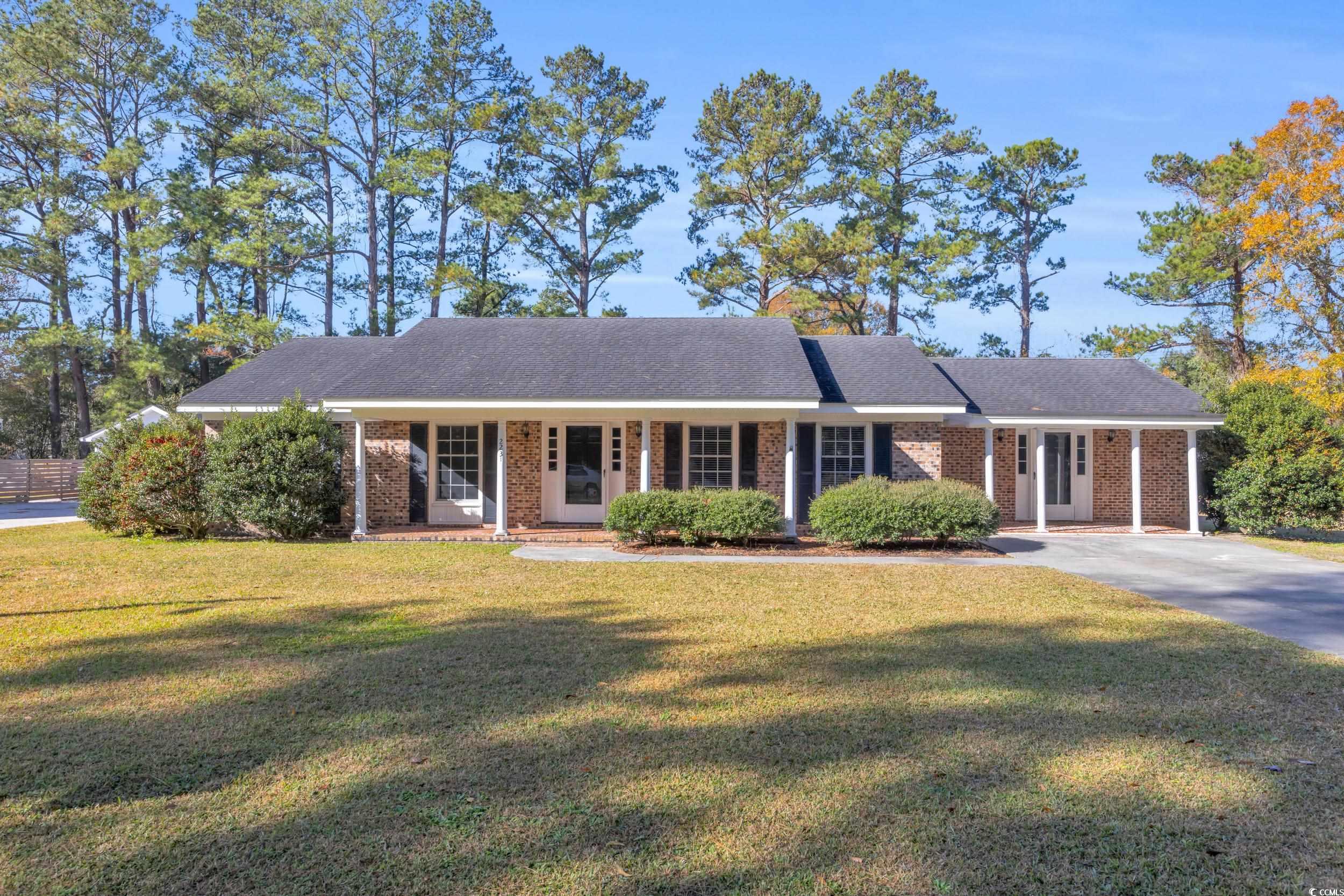 Ranch-style house with a front yard and a porch