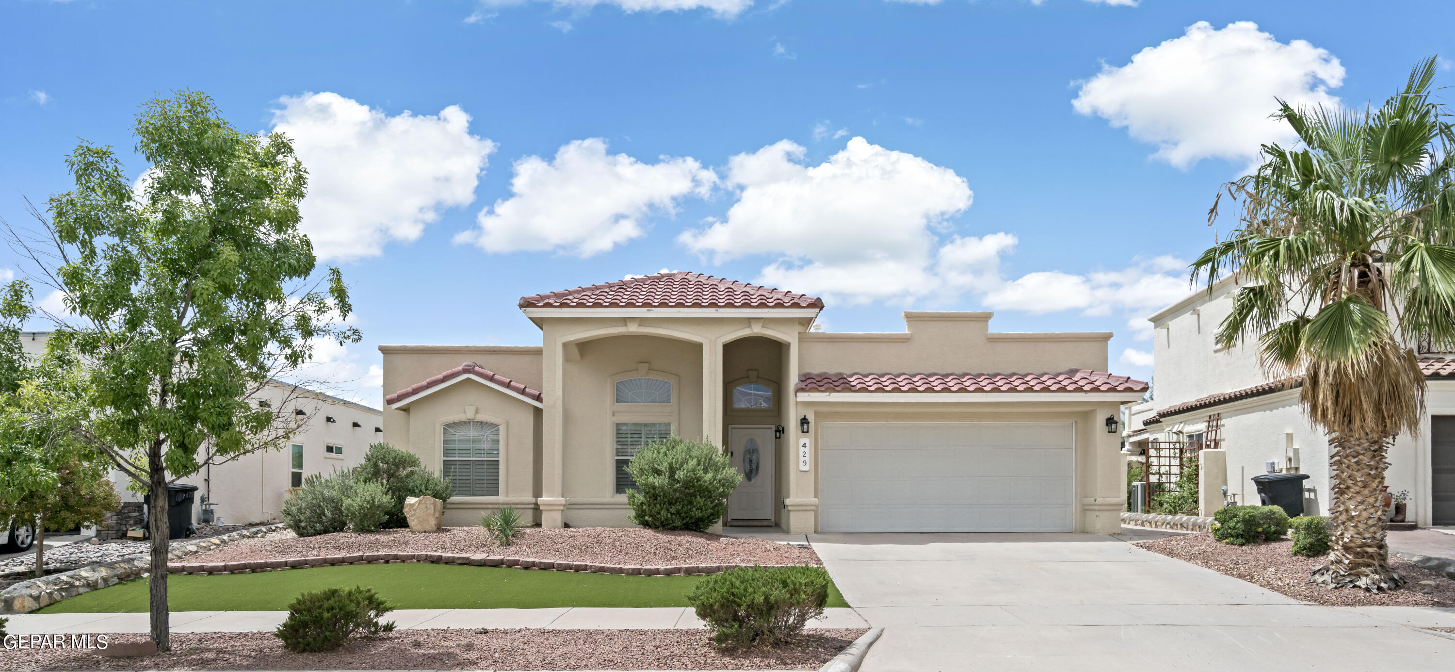 a front view of a house with a garden