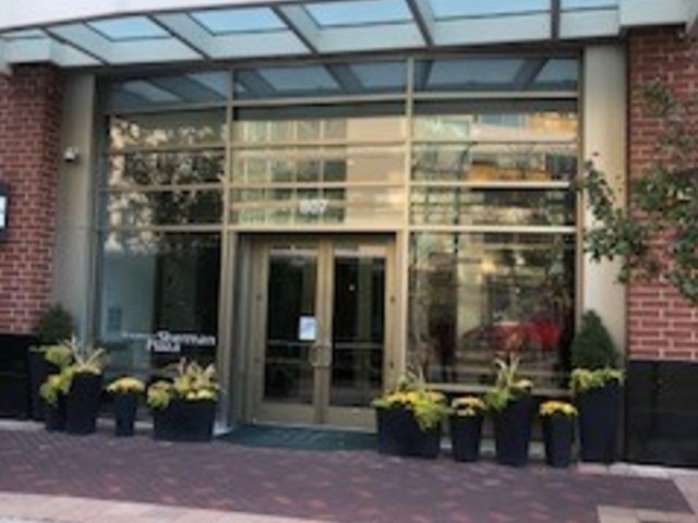 a couple of table and chairs in front of building