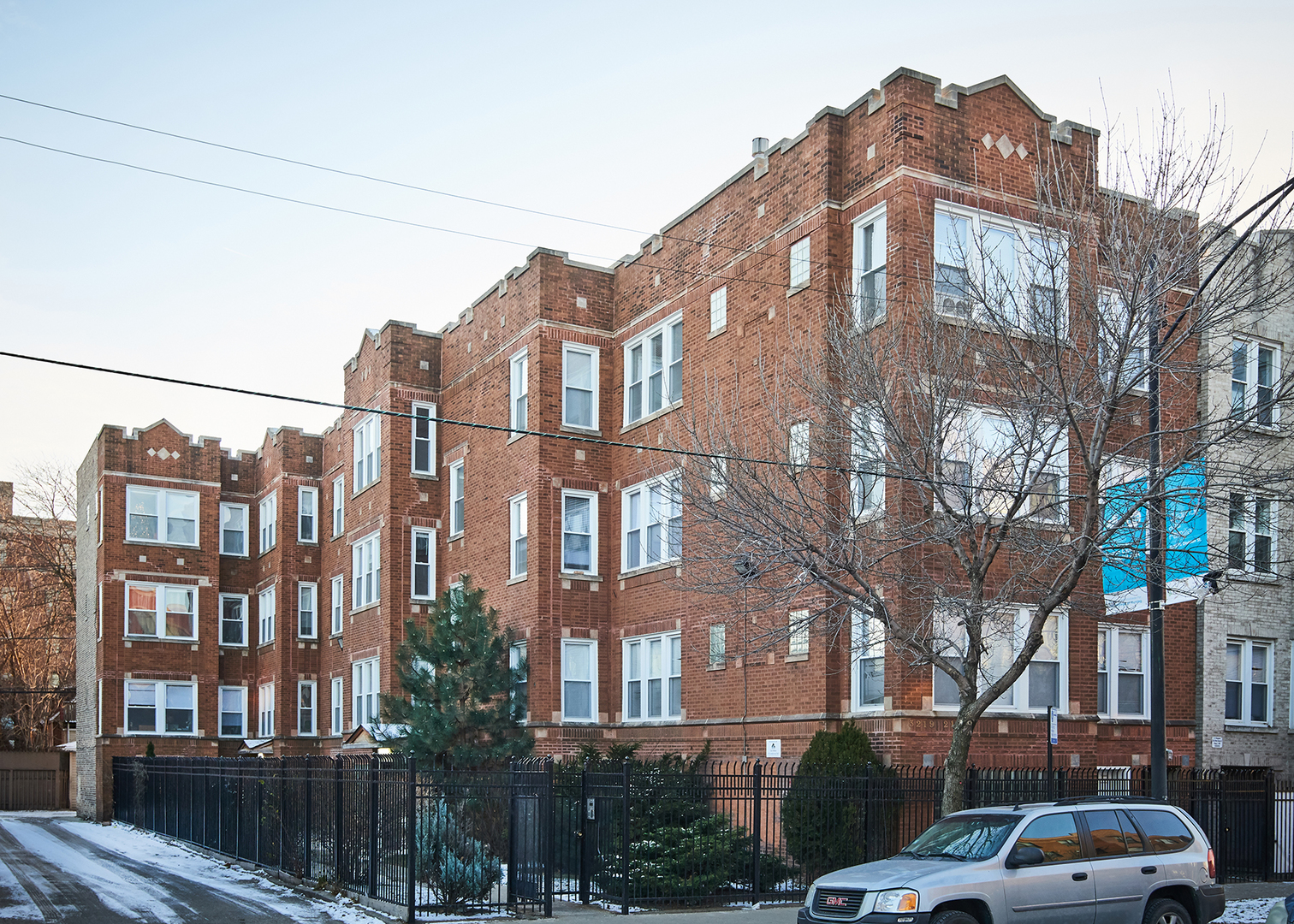 a front view of a residential apartment building with a yard