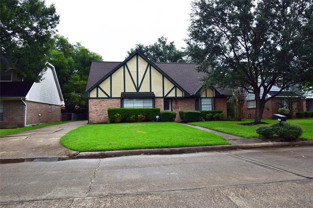 a front view of a house with garage and green space