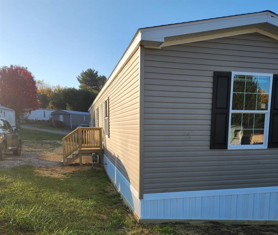 a view of backyard with deck and outdoor seating