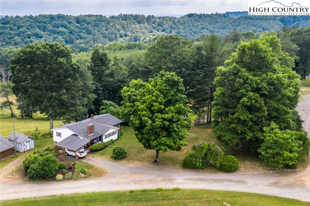 an aerial view of a house with yard