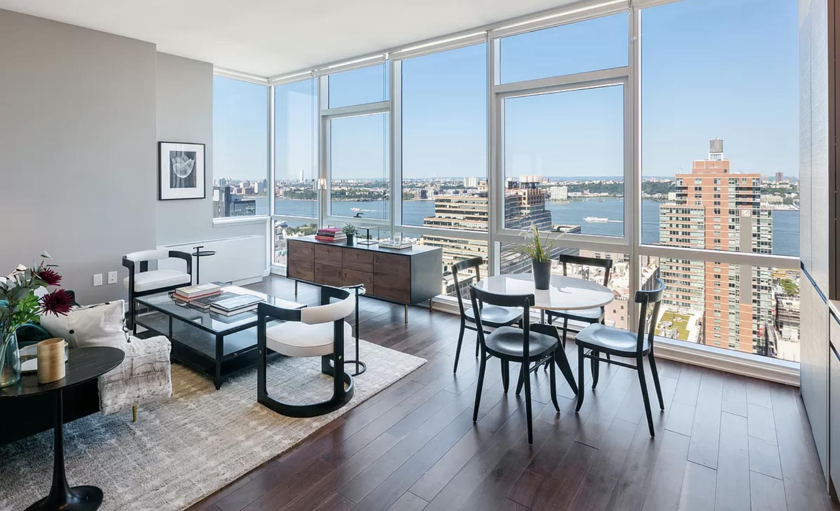 a dining room with furniture window and wooden floor