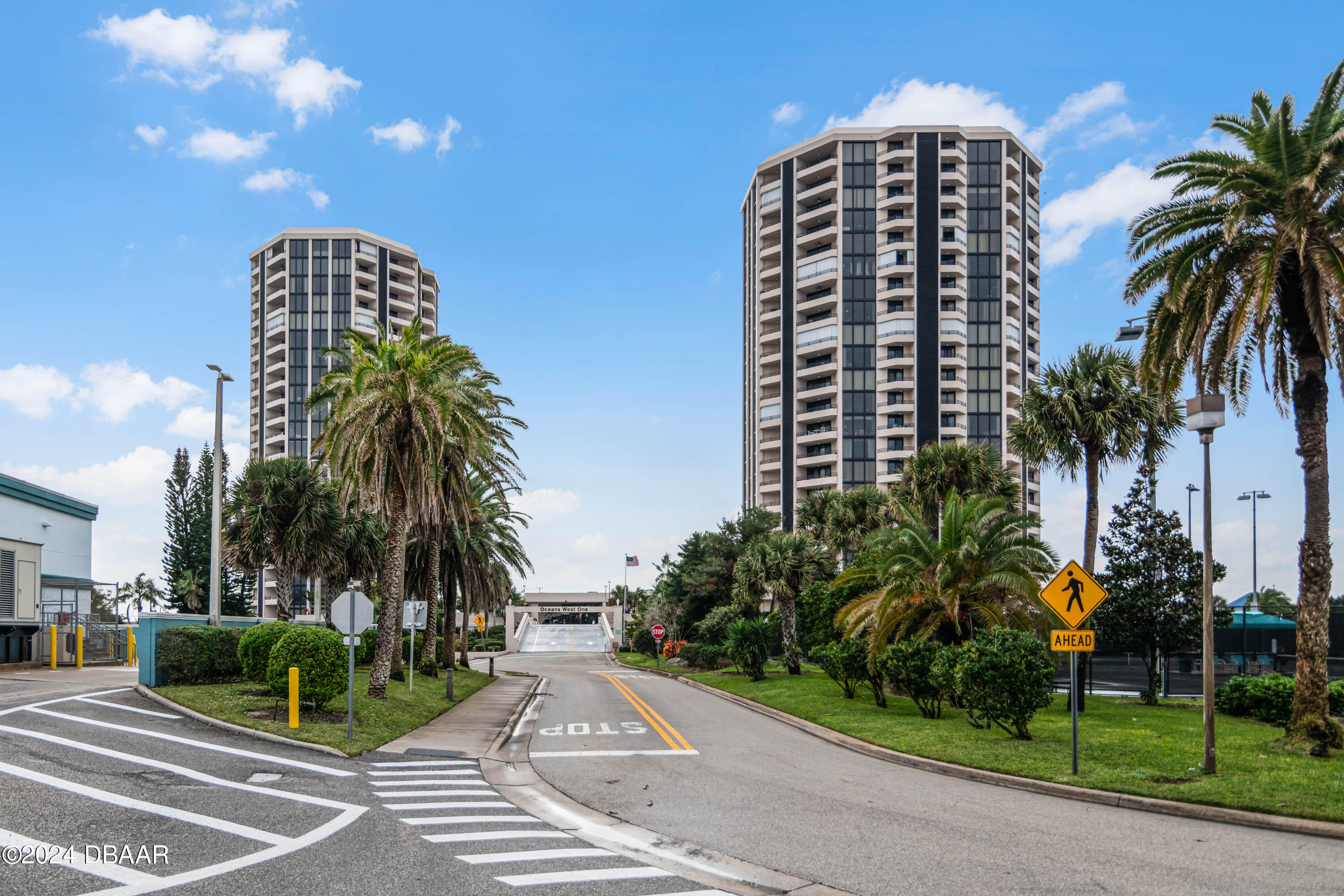 a view of a tall building next to a yard