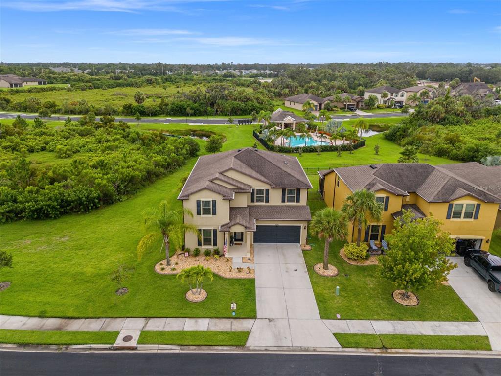 an aerial view of a house with big yard