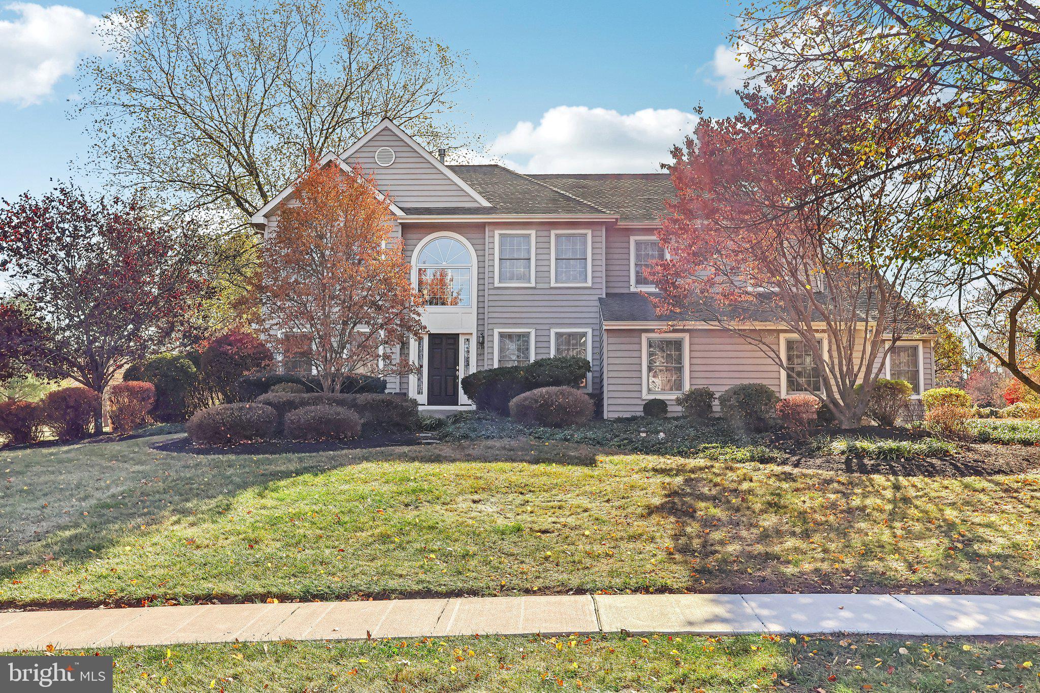 a view of a yard in front of a house with a fountain