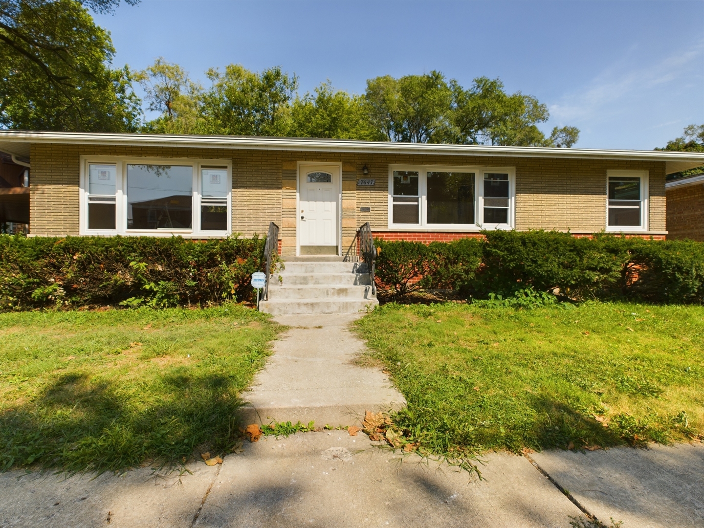 a front view of house with yard and green space