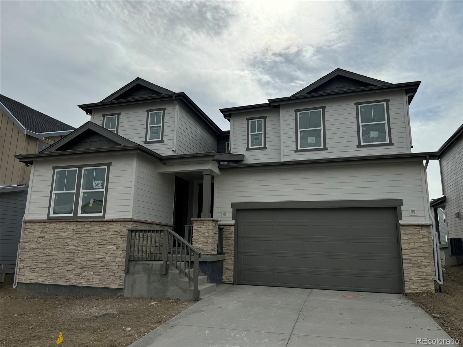 a front view of a house with garage