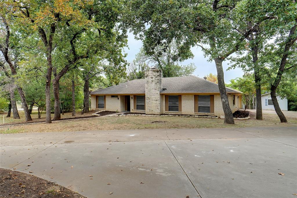 a front view of a house with a yard and a garage