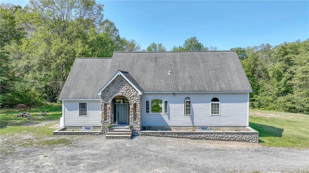 an aerial view of a house with a yard