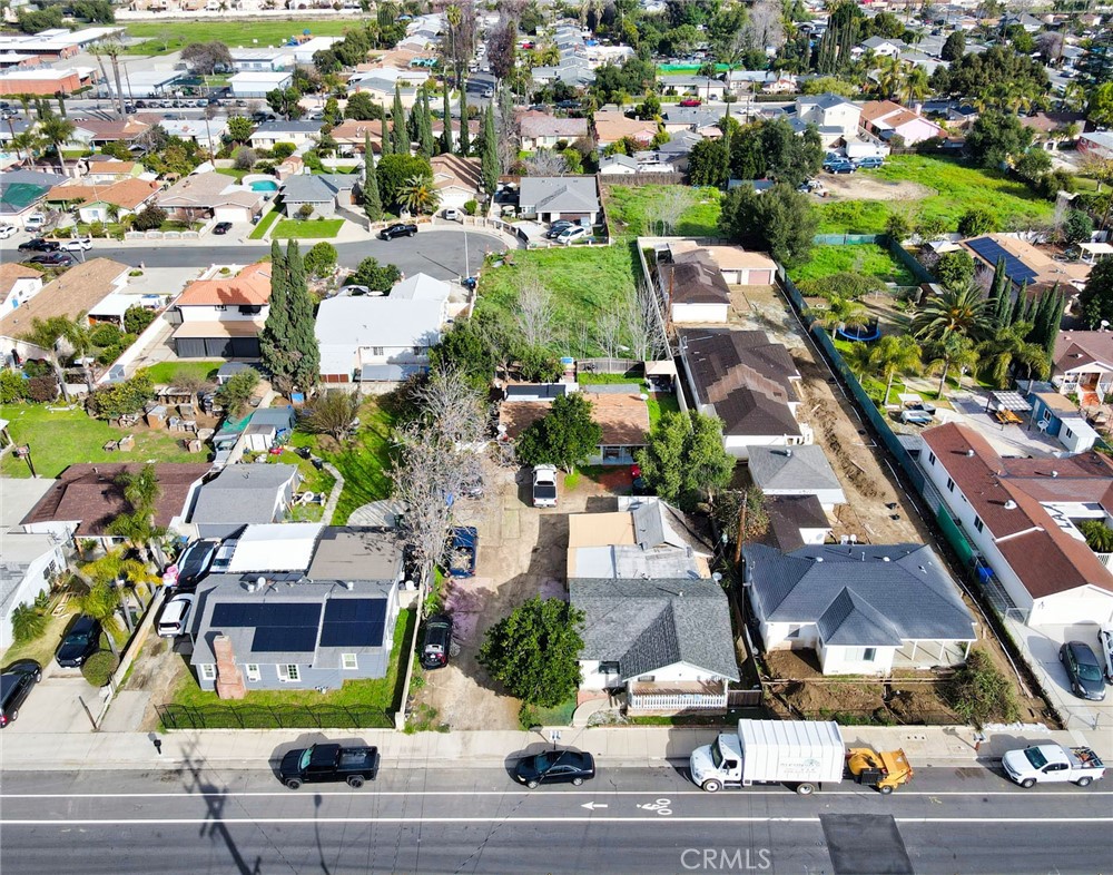 an aerial view of residential houses with yard