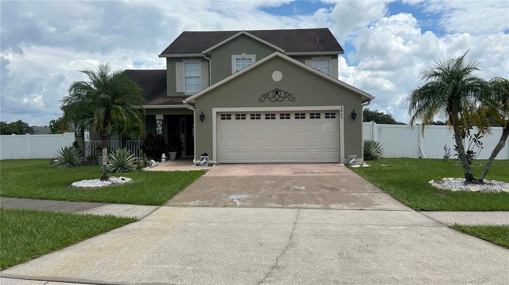 a front view of a house with a yard and garage