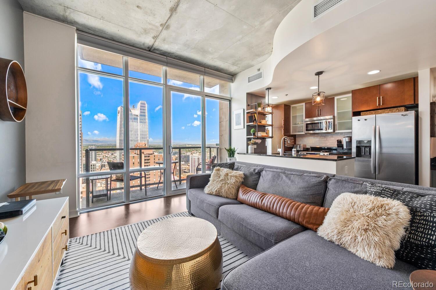 a living room with furniture and a floor to ceiling window