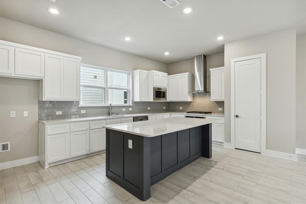 a kitchen with a sink stove and cabinets