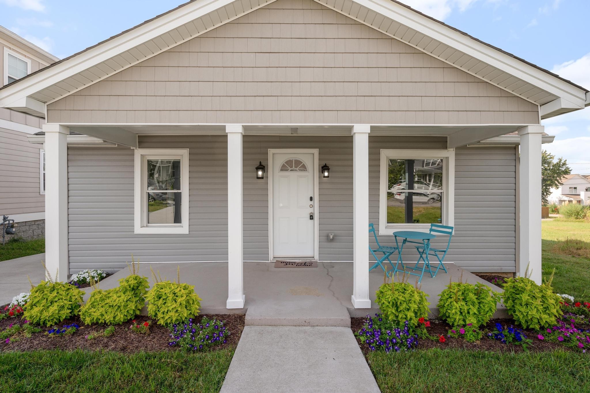 a front view of a house with a garden