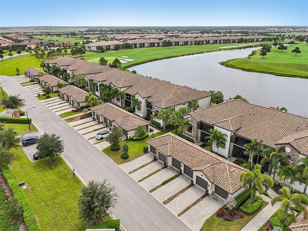 an aerial view of residential houses with outdoor space and river