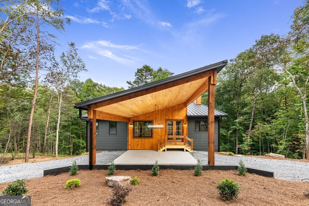 a view of a house with backyard porch and sitting area