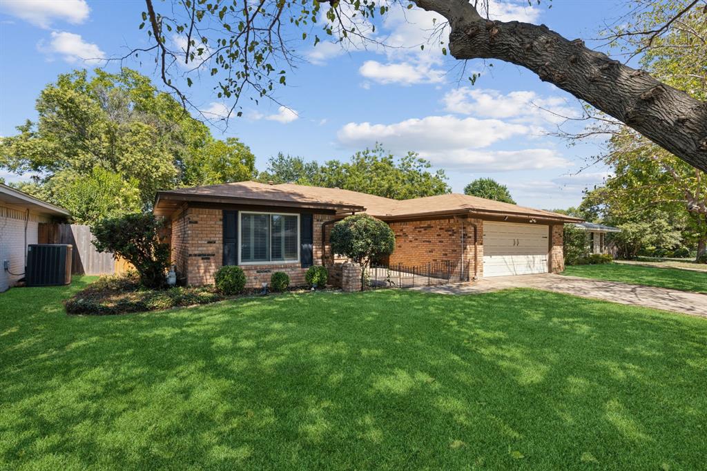 a view of a house with a yard and sitting area