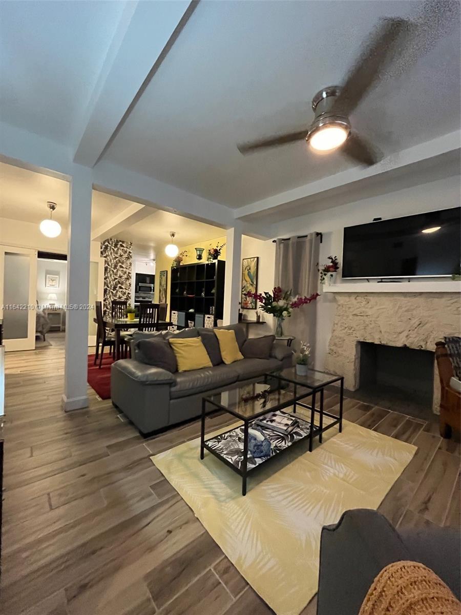 a living room with furniture fireplace and flat screen tv