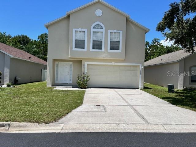 a front view of a house with a yard and garage