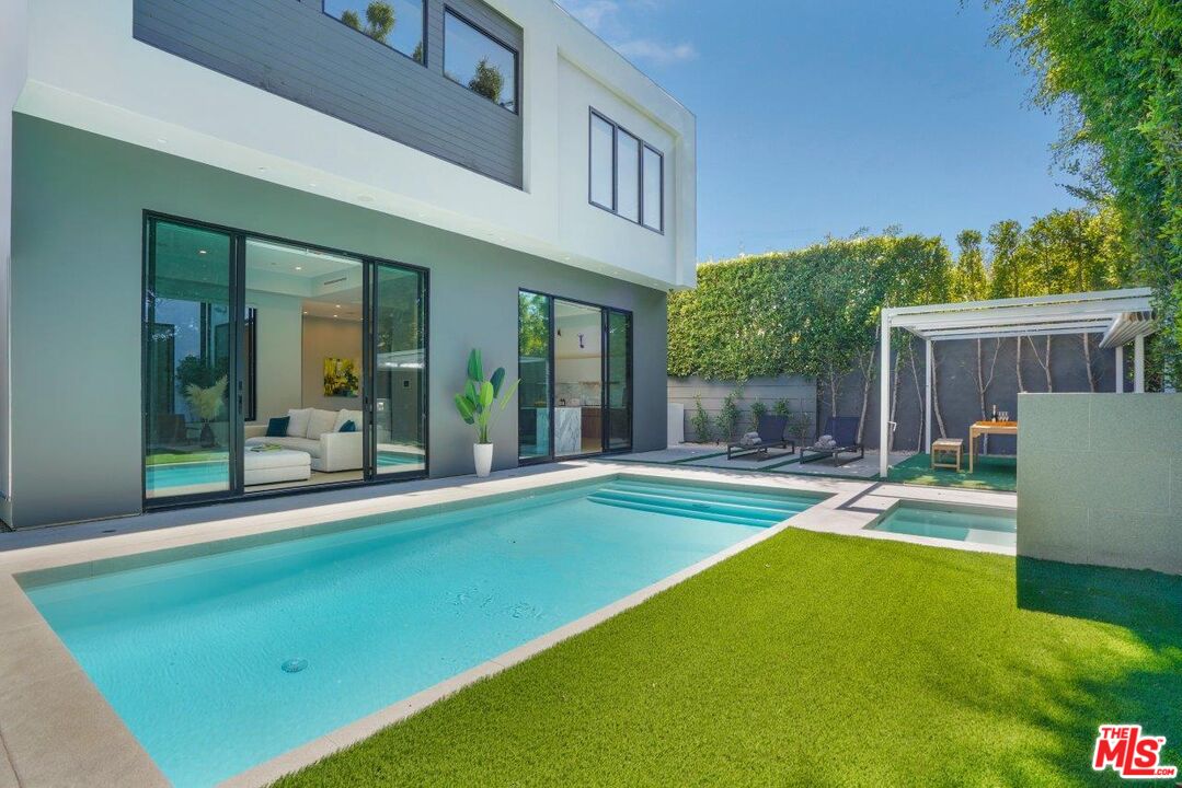 a view of a house with swimming pool and porch with furniture