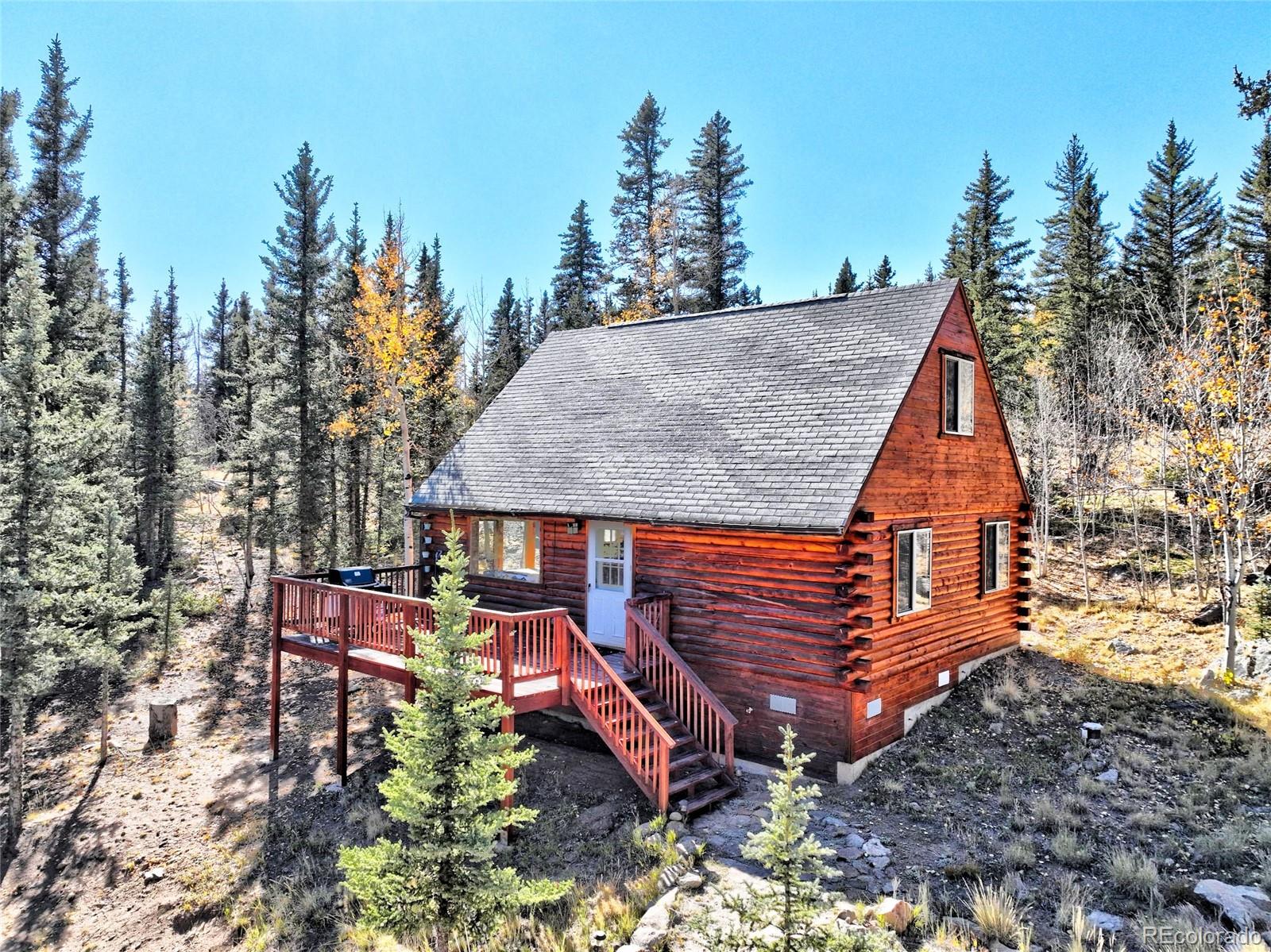 an aerial view of a house with a yard and sitting area