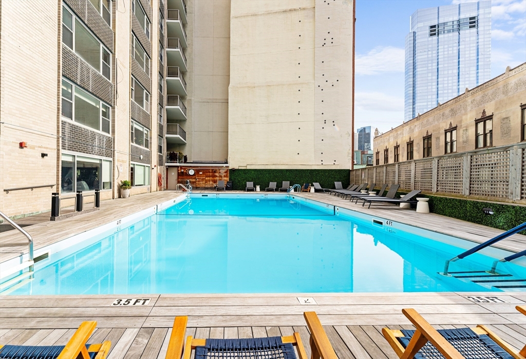 a view of a swimming pool with a lounge chair