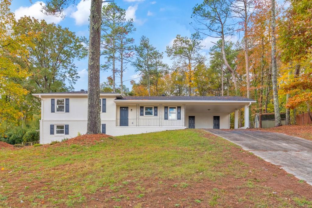 a house that has a tree in front of it