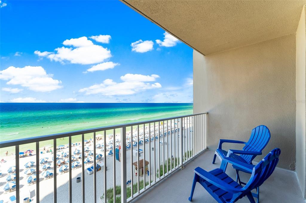 a view of a two chairs in the balcony