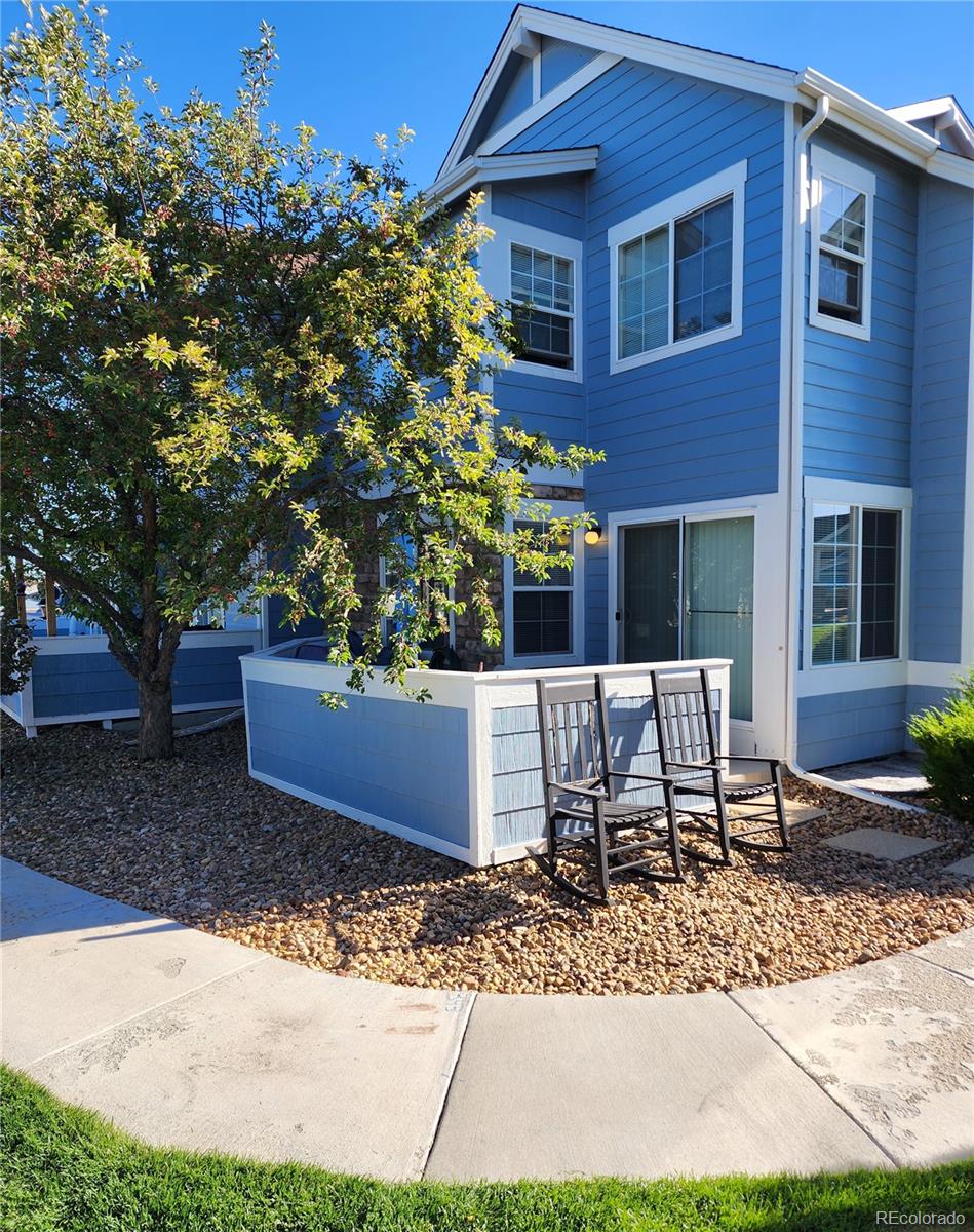 a view of a house with a yard and sitting area