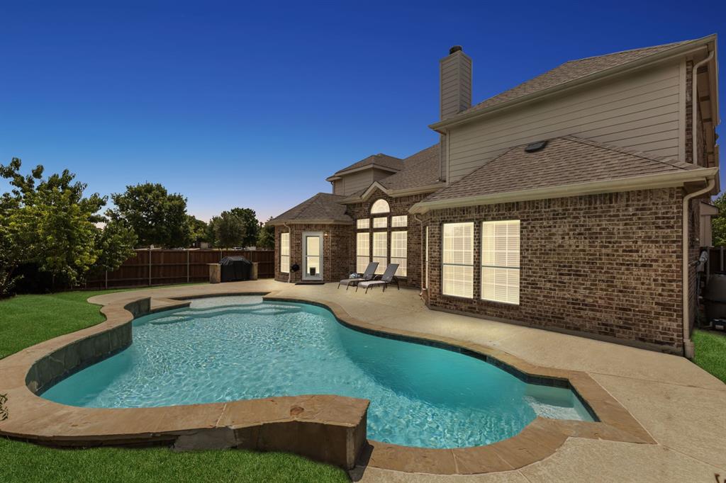 a view of a house with swimming pool and yard