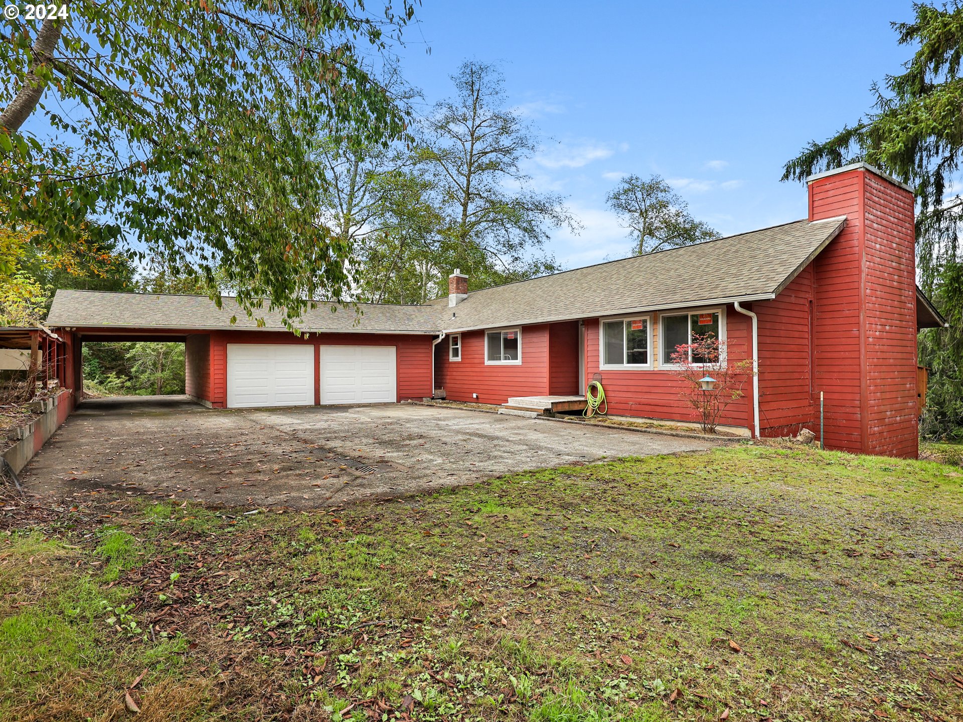 a view of a house with a yard and garage