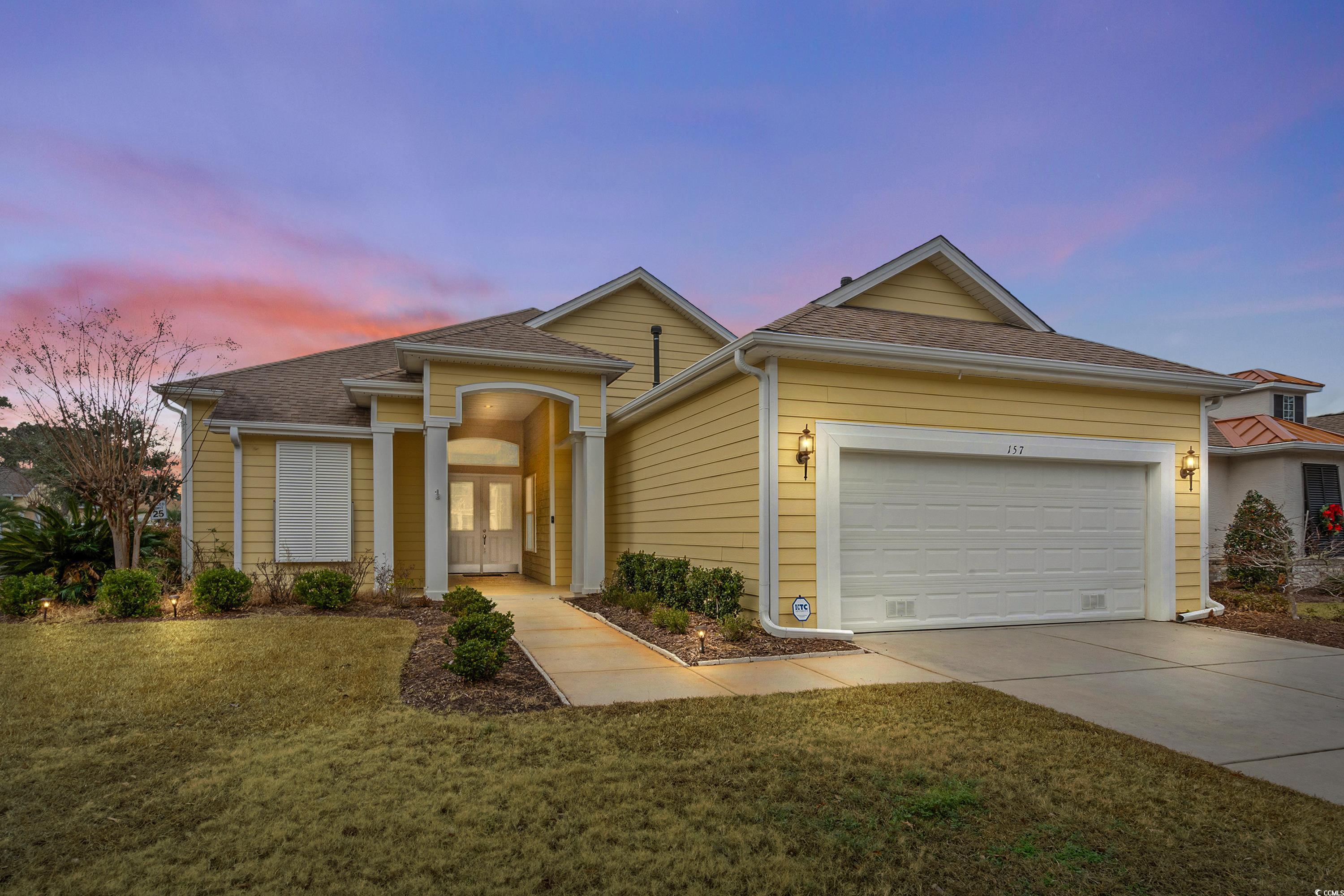 View of front of property with french doors, a gar