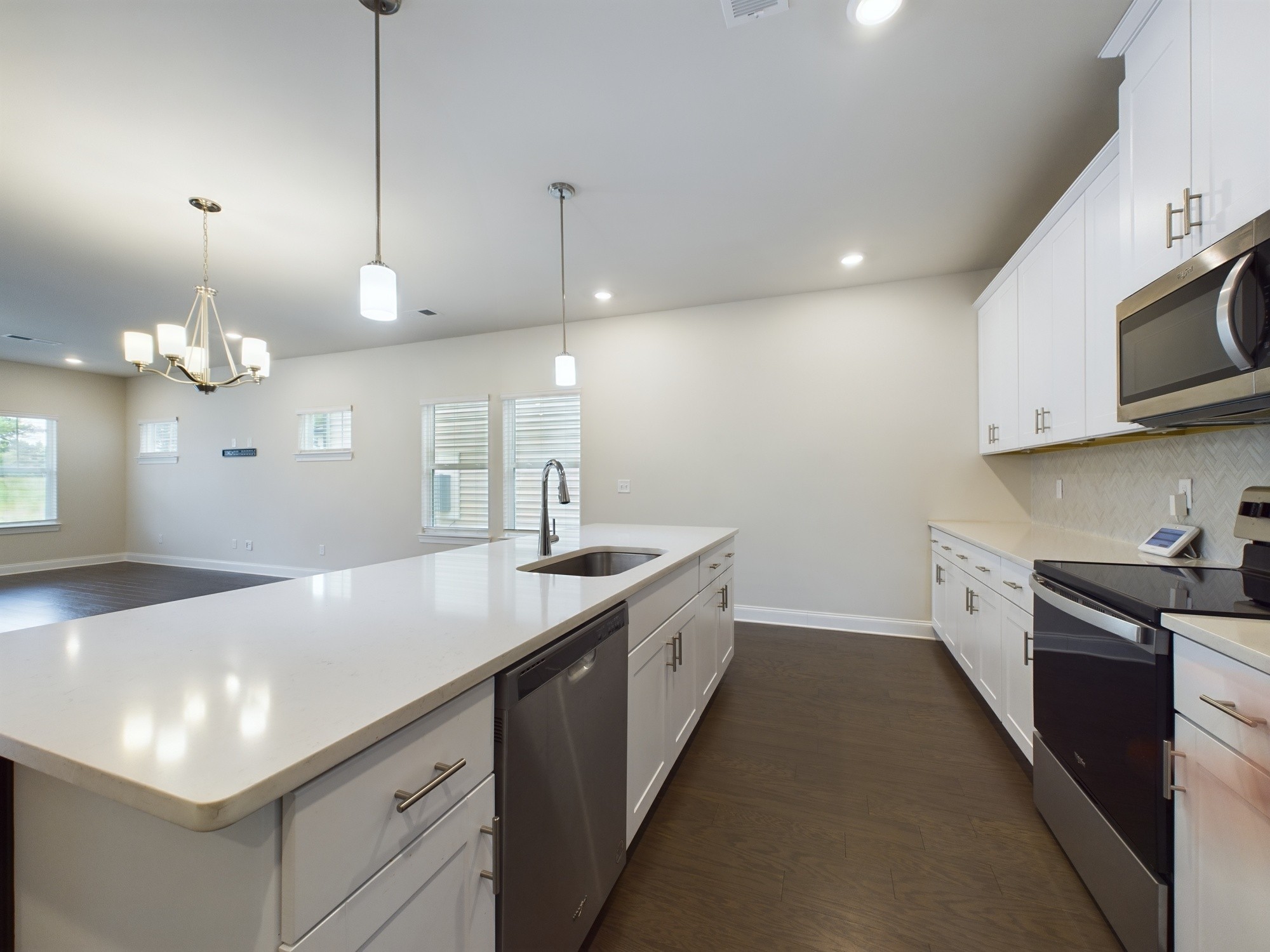 a kitchen with kitchen island a sink stainless steel appliances and cabinets