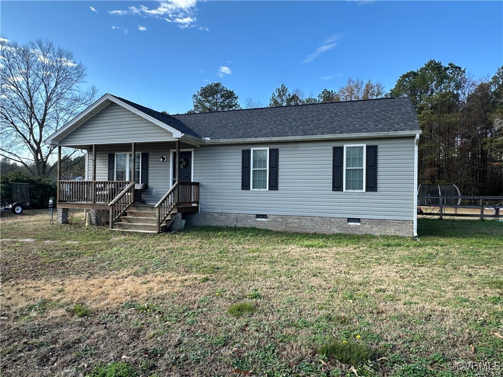 View of front of home with covered porch and a fro