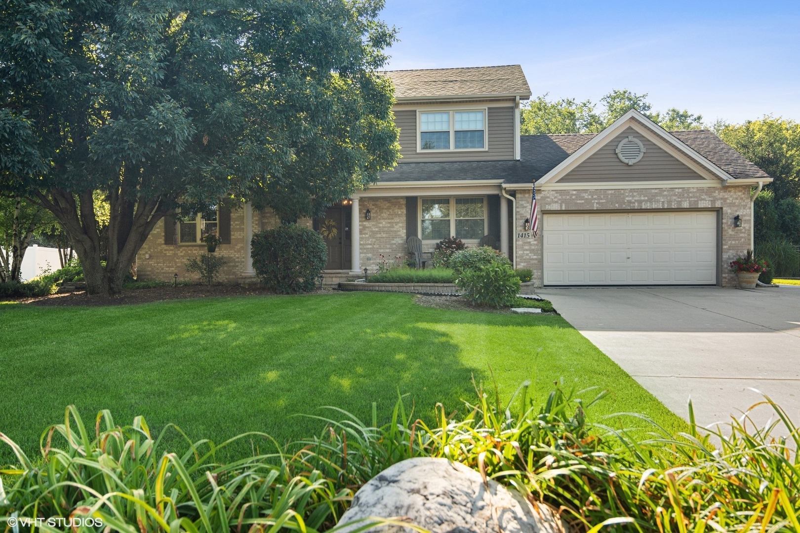 a front view of a house with garden