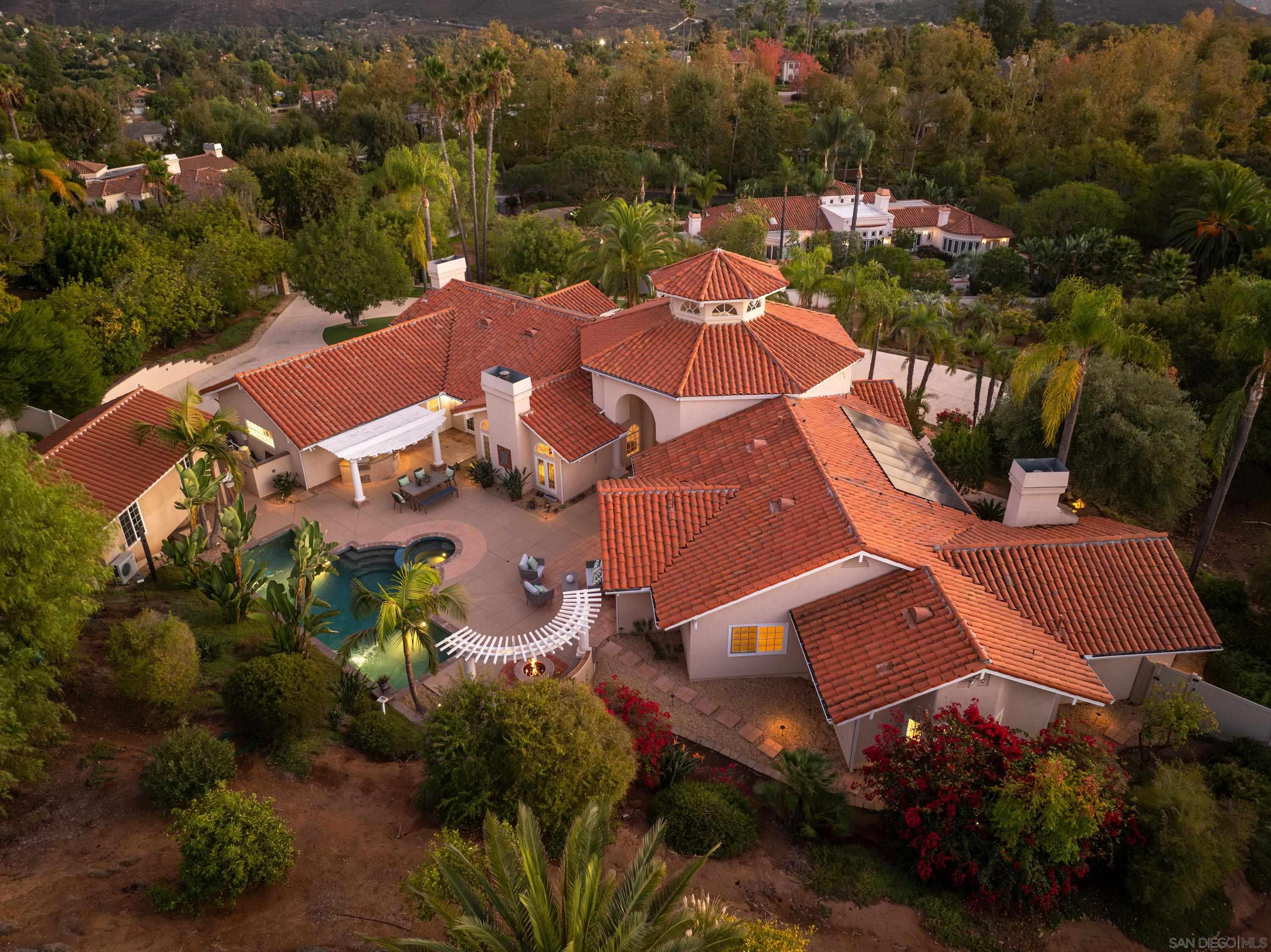 an aerial view of a house with garden space and street view