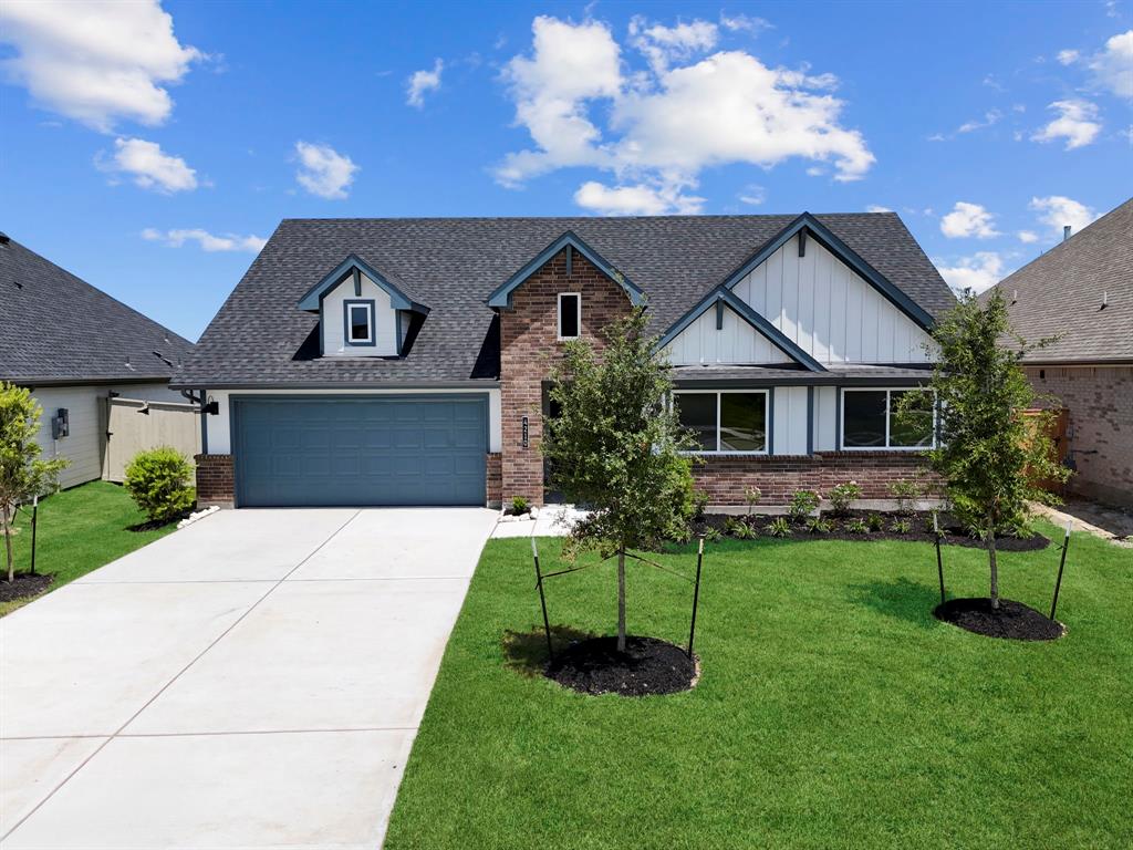 a front view of a house with a yard and outdoor seating