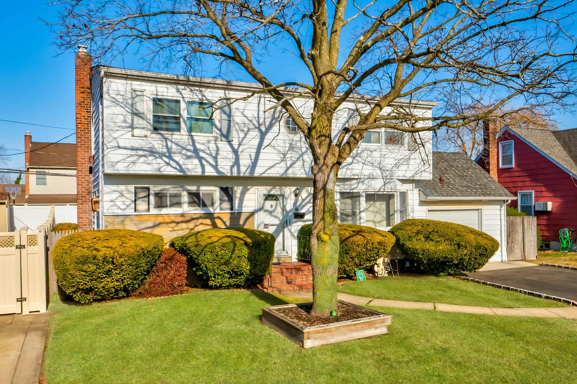 View of front of property with a garage and a front yard